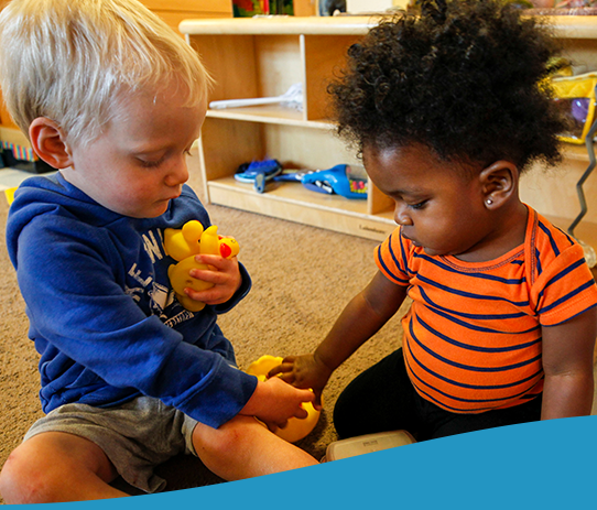 Children sharing a toy